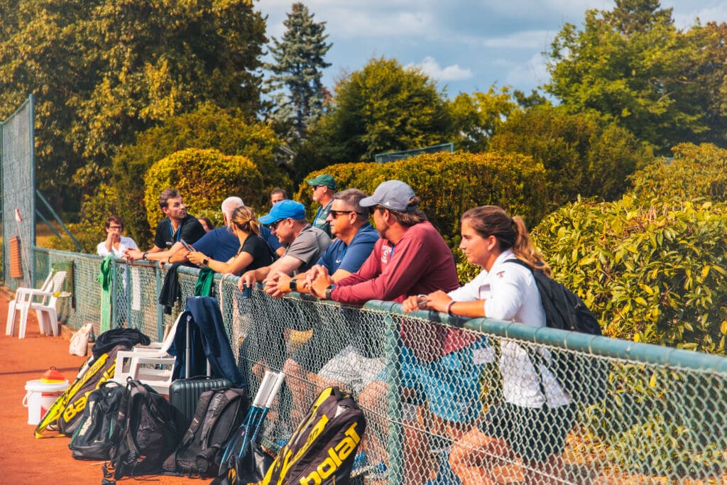 College coaches watching tennis match