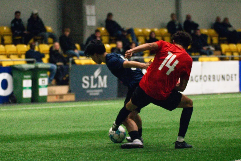 Two players fight for a ball as college coaches look on at the Keystone Sports College Soccer Showcase