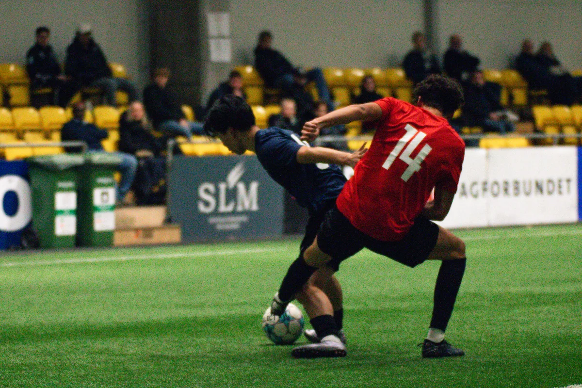 Two players fight for a ball as college coaches look on at the Keystone Sports College Soccer Showcase